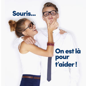 Portrait of a young man wearing glasses with his face being squashed by a pretty young woman
